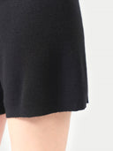 Black skirt worn by a person on a white background #color_black