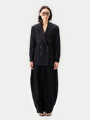 Woman wearing a black suit with a white background #color_black