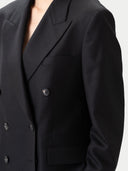 close up of a black double-breasted blazer on a white background #color_black