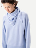Person wearing a light blue sweater with scarf on a white background #color-cashmere-blue