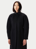 Person wearing a black coat on a white background #color_black