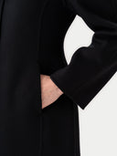 Black coat with hand in pocket on a white background #color_black