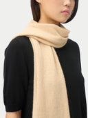 Person wearing a beige scarf over a black outfit on a white background #color_beige