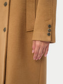 Close-up of a brown coat with buttons on a white background  #color_almond