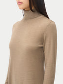 close up side view of a woman wearing a turtleneck sweater worn by a person on a white background #color_taupe