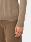 Close-up of a person wearing a brown sweater and pants on a white background #color_taupe