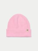 Pink beanie hat with a brand logo on a light gray background.