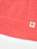 Red Pink knit beanie with a brand label on a white background  #color_coral