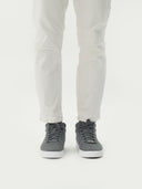 front view of a gray high top cashmere sneakers and white pants  #color_stone-gray