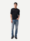 front view of a man wearing a black t-shirt and blue jeans on a white background #color_blue-graphite