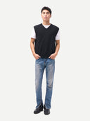 front view of a person wearing a black vest, white shirt, blue jeans, and black shoes on a white background #color_black