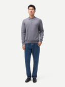 Man wearing a gray sweater and blue jeans on a white background #color_dim-gray