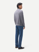 Person wearing a gray sweater and blue jeans on a white background #color_dim-gray