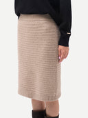 Beige knitted skirt worn by a person on a white background #color_fog