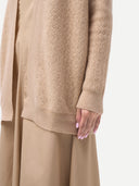 close up of a beige textured cable knit sweater and wide-leg pants on a white background #color_beige