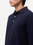 Navy blue polo shirt worn by a person on a light gray background. #color-navy
