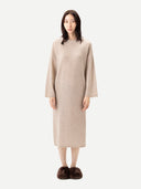 Woman wearing a beige dress with brown shoes on a white background #color_warm-grey
