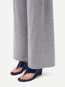 bottom-side of a person wearing gray pants and navy sandals on a white background  #color_high-rise