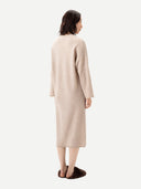 Back view of a woman wearing a beige long coat on a white background #color_warm-grey