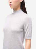 Close up of a gray turtleneck short-sleeve sweater worn by a person on a white background #color_vapor-blue
