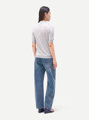 Back-view of a person wearing a gray t-shirt and blue jeans on a white background #color_vapor-blue