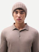 Man wearing a beige knit beanie and matching long-sleeve shirt against a white background #color_taupe