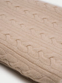 close up a beige cable knit blanket with a subtle pattern. #color_beige