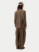 Back view of person wearing a brown suit on a white background #color_sepia