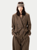 Person wearing a brown suit with a plain background #color_sepia