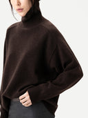 Close up of a brown turtleneck sweater worn by a person on a white background #color_mole