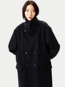 Person wearing a black coat against a white background #color_black