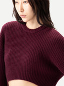 Close up of a maroon knitted sweater on a white background #color_burgundy