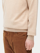 Beige sweater and brown pants on a white background