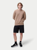 front view of a man wearing a brown silk sweater and black shorts. #color_timber-wolf