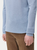 closed up of light blue sweater, brown pants #color_celestial-blue