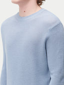 close up of a light blue sweater detail #color_celestial-blue