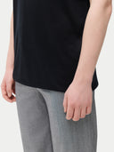 close up of a black top and gray pants #color_black