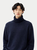 Man wearing a navy turtleneck sweater against a white background #color_navy