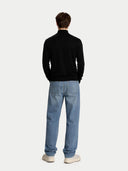 back view of a person wearing a black sweater and light blue jeans on a white background #color_blue-graphite