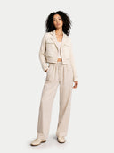 Woman wearing a beige outfit on a white background #color_off-white