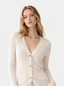 Woman wearing a cream-colored cardigan on a light gray background #color_coconut-milk