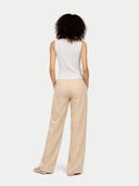 back view of a white sleeveless top and beige pants on a white background #color_whisper-white