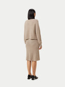 back view of a beige cropped turtle neck sweater and skirt #color_warm-grey