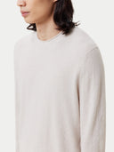 close up of a white minimal lightweight sweater with a little rolled collar #color_silver-birch