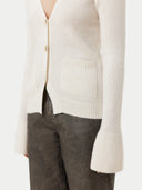 close up of a v neck cardigan with long sleeves, pockets #color_coconut-milk