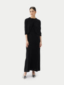 Front view of a black short-length capelet over a black dress on a light gray background #color_black