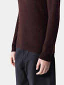 close up of a brown sweater and black pants #color_coffee-bean