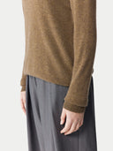close up of a brown sweater and gray pants #color_lead-gray