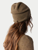 back view of a brown beanie with a small label tag #color_lead-gray
