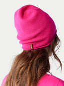 back view of a bright pink beanie with a small tag label "GOBI" #color_magenta